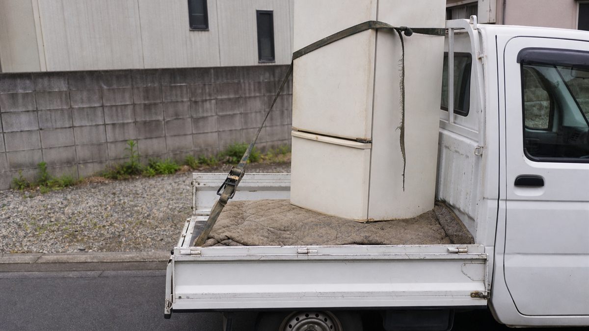 軽トラックの荷台に毛布を敷いて固定した冷蔵庫